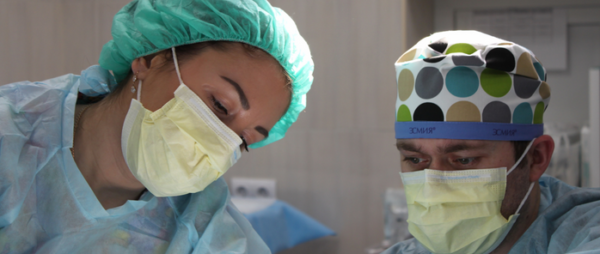 Physician Assistant performing surgical procedure with colleague