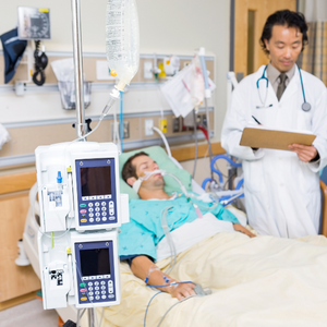 IM Certification Exam: Residency as a Study Tool — Physician reviewing chart for ICU patient